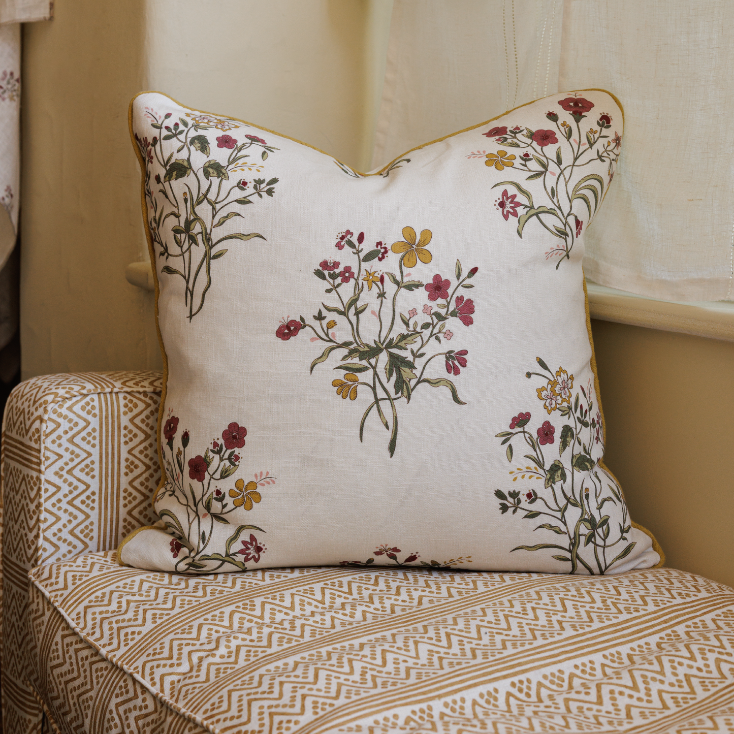 Large Flax & Field Flowers Scarlet Print Cushion with Ochre Piping