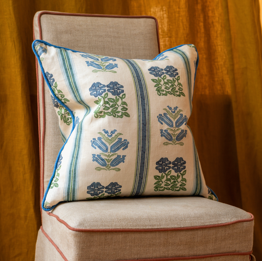 cushion in volga's folkloric floral print with cornflower blue trim