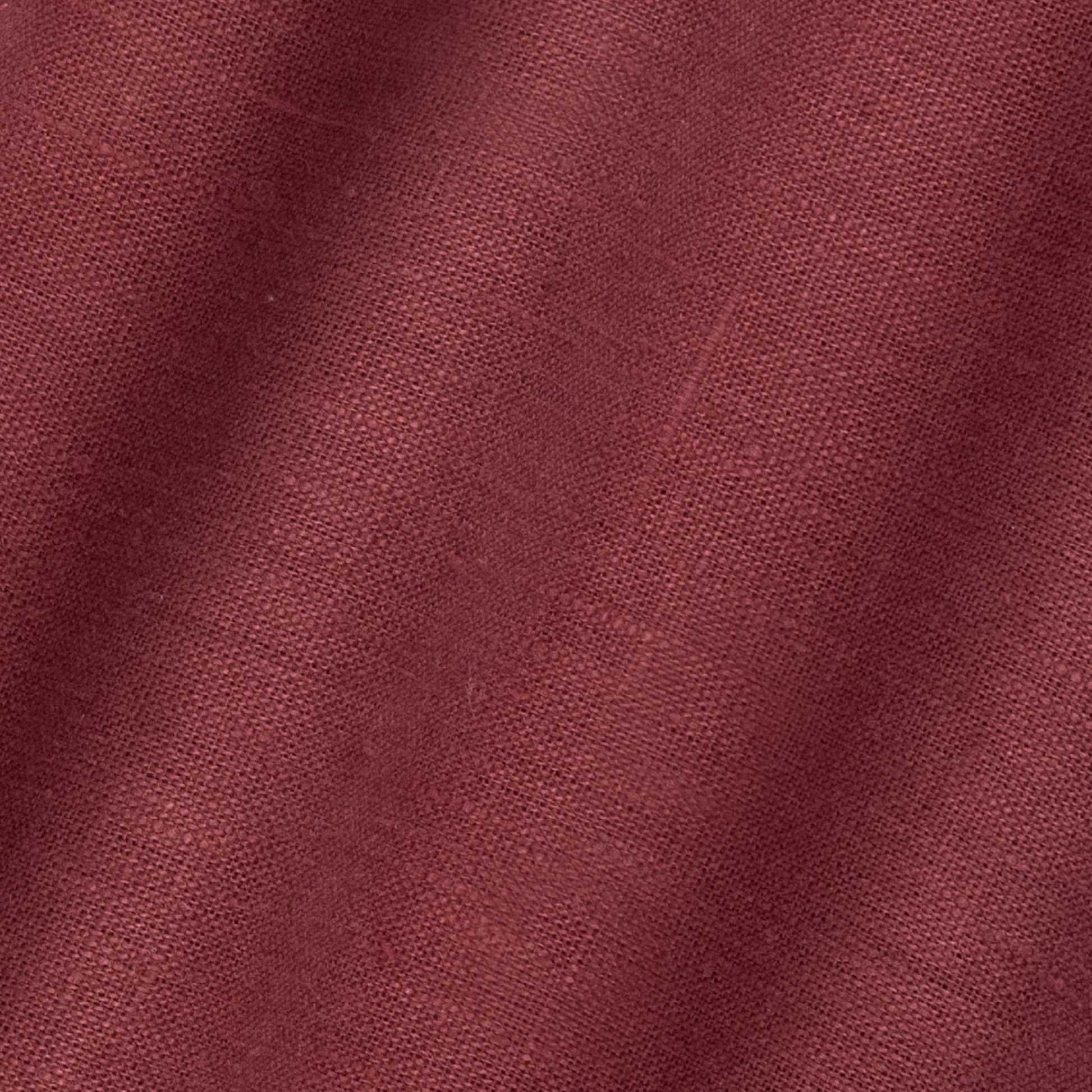 detail of light weight plain linen in scarlet colour