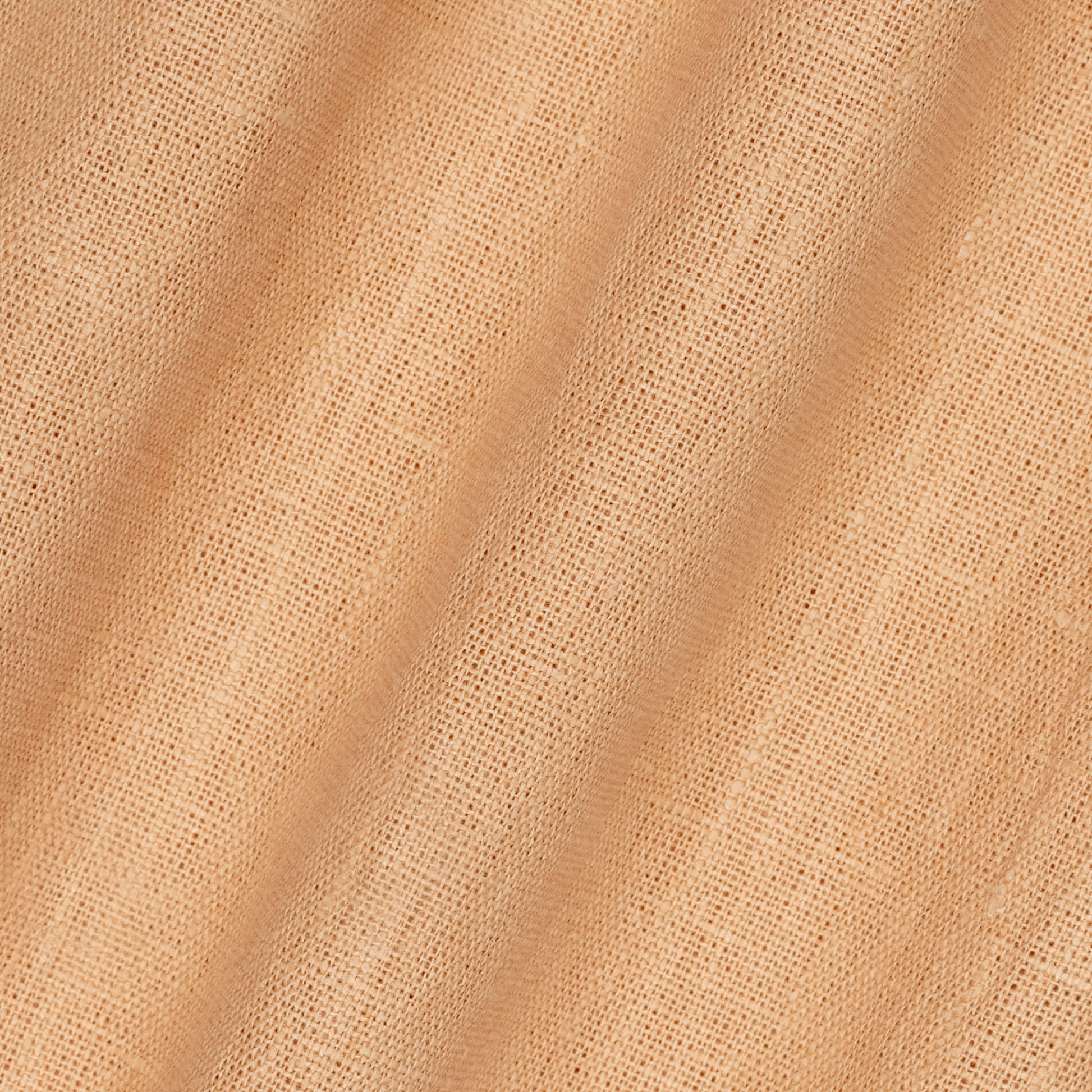 detail of light weight plain linen in peach colour