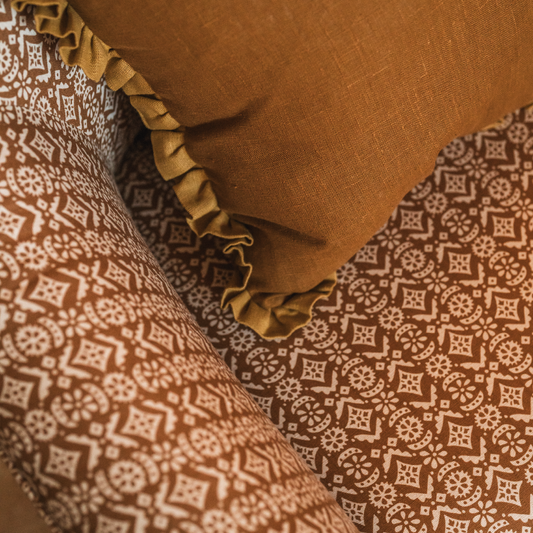close up of armchair in hawelka old gold printed linen