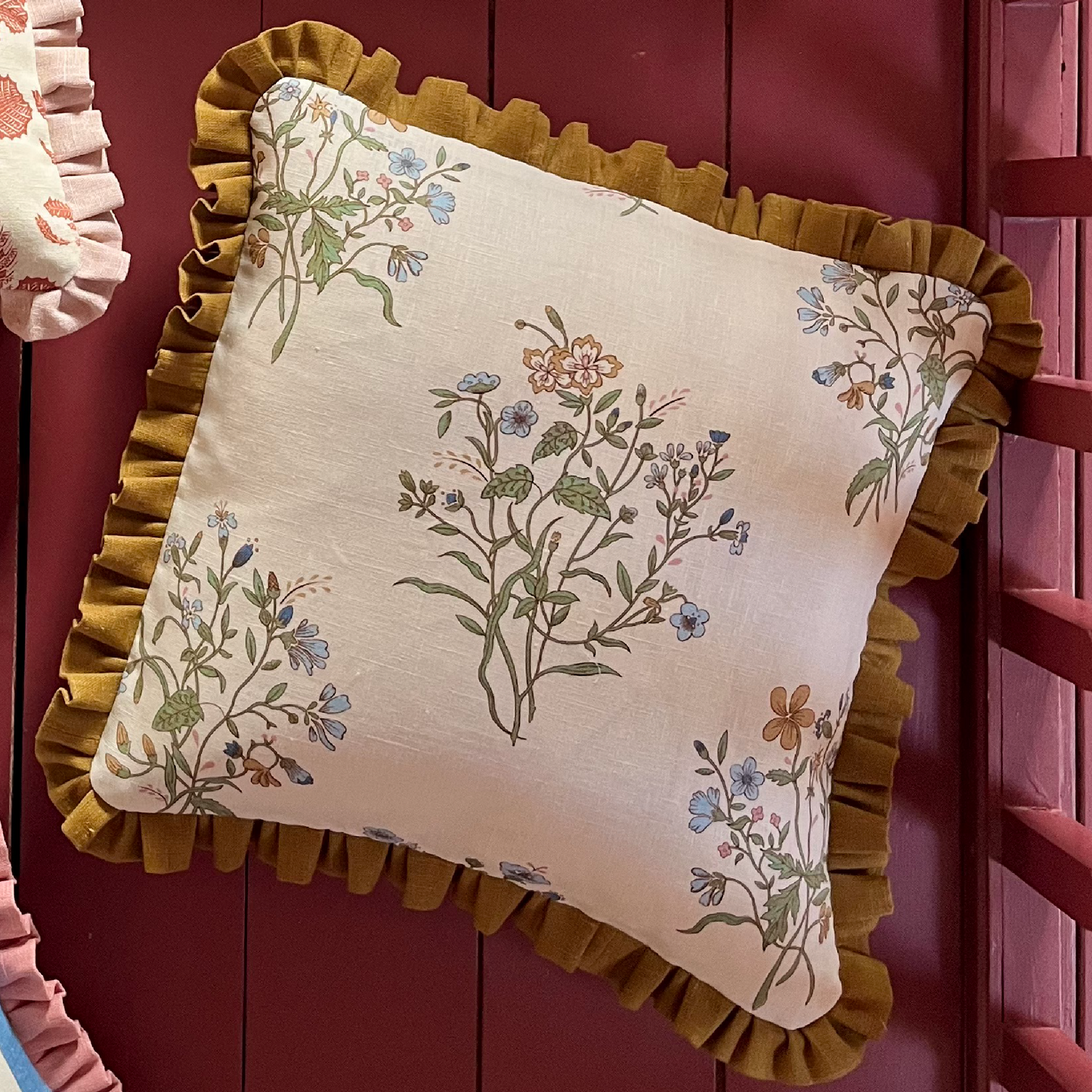 cushion in floral print with old gold trim