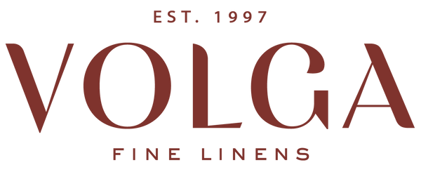 Logo of Volga Fine Linens with establishment year on a white background