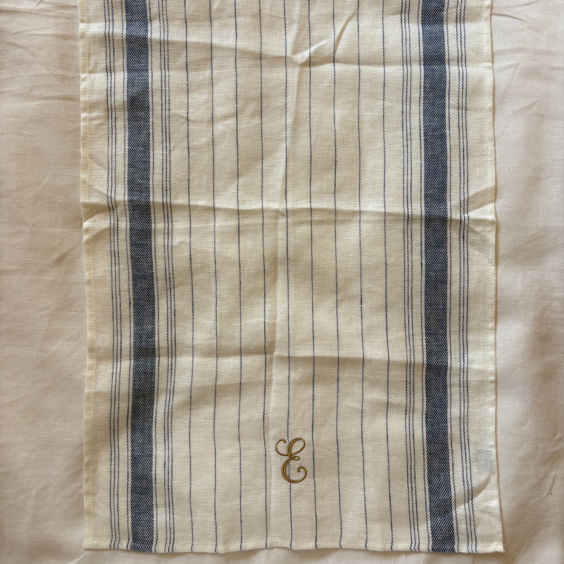Striped fabric with embroidered design on a beige background