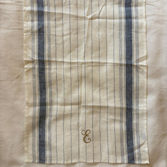 Striped fabric with embroidered design on a beige background
