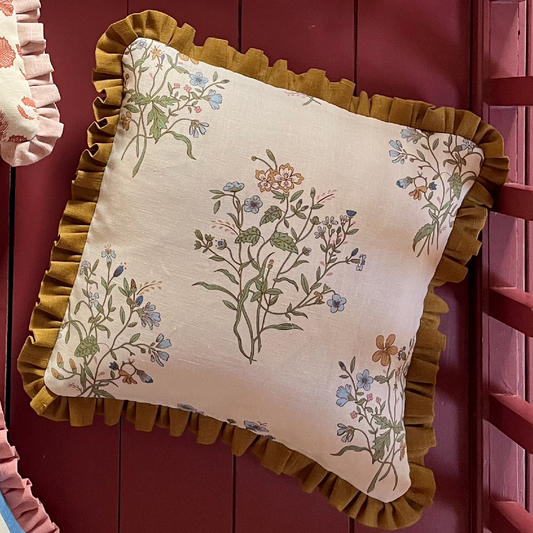 cushion in floral print with old gold trim